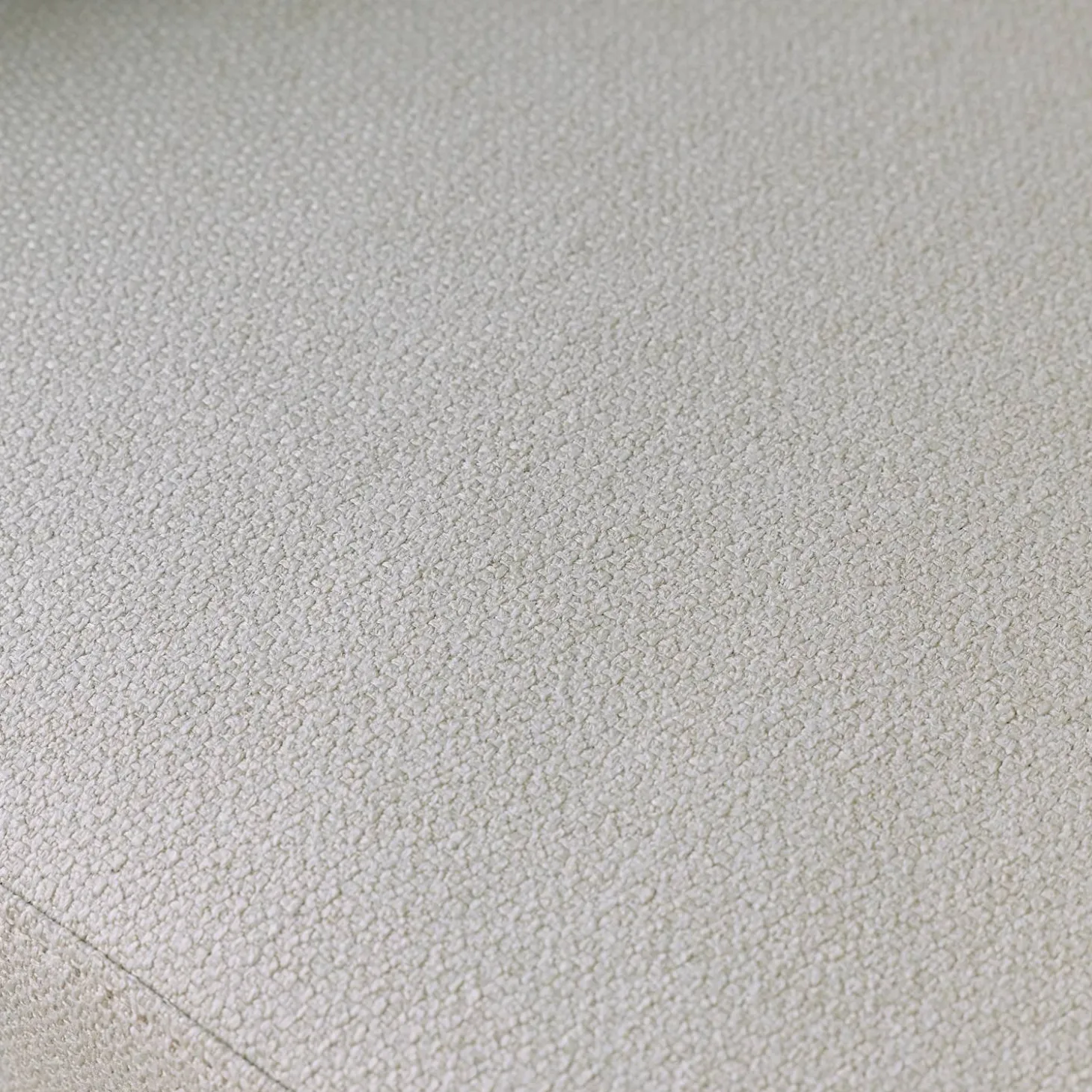 Sillón de tela con respaldo curvo y patas de metal
