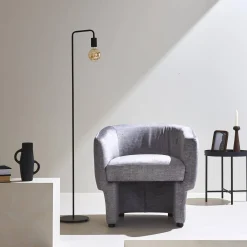 Sillón de tela con respaldo y base redondeada
